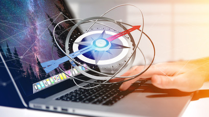 Poster - Business man using a navigation compass on a laptop - 3d rendered