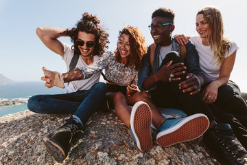 Wall Mural - Friends on mountain top taking selfie