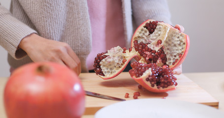 Sticker - Putting Fresh red pomegranate into bowl