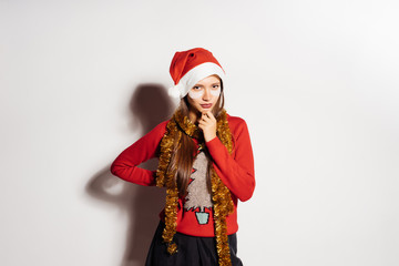 pensive beautiful girl in red New Year's clothes thinks about something, under the eyes white patches