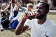 © Viacheslav Yakobchuk - Fizzy drink. Good looking pleasant delighted man holding a bottle of coke and drinking it while being thirsty