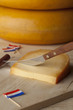 Piece of Dutch mature Gouda cheese on a cutting board