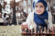 © Viacheslav Yakobchuk - Intellectual game. Delighted nice smart woman lying on the grass and smiling while playing chess