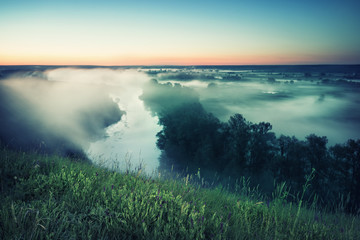 Wall Mural - misty morning on river under hill