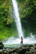 Costa Rica, Arenal Volcano National Park, Woman At The Waterfall Of La Fortuna
