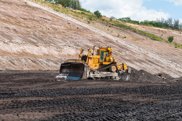 Wall Mural - Mining Equipment or Mining Machinery, Bulldozer, wheel loader, shovels, loading of coal, ore on the dump truck from open-pit or open-cast mine as the Coal Production.