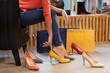 © Syda Productions - young woman trying high-heeled shoes at store