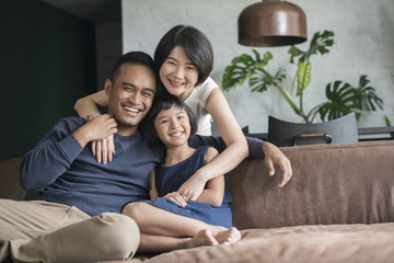 Happy Asian family using the computer together at home.