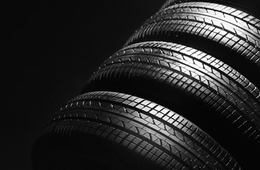 Wall Mural - Car tires on black background