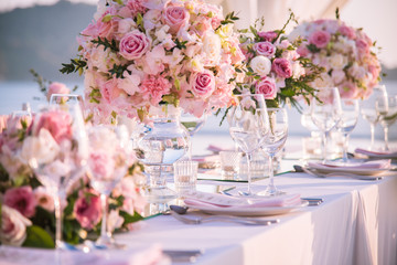 table setting at a luxury wedding and beautiful flowers on the table.