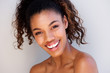 © mimagephotos - Close up attractive young woman smiling against white background