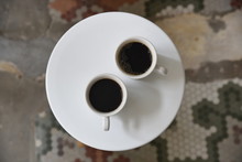 Overhead View Of Black Coffee Cups On Table
