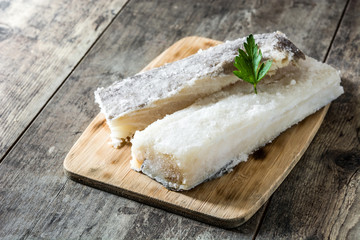 Salted dried cod on wooden table. Typical Easter food