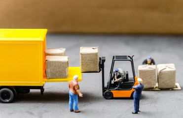 miniature warehouse workers forklift carrying goods box to semi truck with trailer .logistics warehouse freight transportation concept