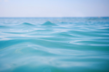  Surface of blue sea water with soft waves and clear sky on horizon. Ocean water background