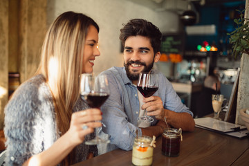 Wall Mural - Romantic couple drinking red wine.