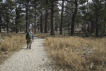 Male Senior Hiker Wearing A Backpack And Carrying A Camera On The Trail Through Mount San Jacinto State Park In Idyllwild, California
