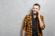 © Africa Studio - Handsome man talking on cell phone against grey background