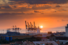 Beautiful Sunset And Industrial Cargo Cranes In Manila Bay