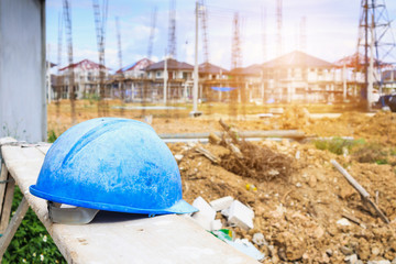 Blue hard hat on house building construction site