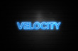 Velocity neon Sign on brickwall