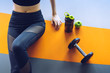 © Kiattisak - Woman exercise workout in gym fitness breaking relax with apple fruit after training sport with dumbbell and protein shake bottle healthy lifestyle bodybuilding, Top view