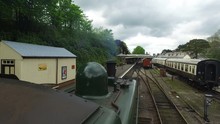 Devon, United Kingdom.  20th Of July 2016.. Mounted Angle Of A Great Western Railway Steam Train Going Through A Railway Station