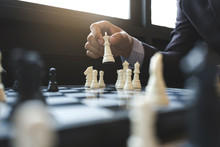 Businessman Playing Chess On Board In Office, Strategy And Competition Concept