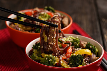 Wall Mural - Brown rice noodles with meat and vegetables, oriental style cuisine.