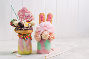 Wall Mural - Two Easter freak shakes on grey background with copy space