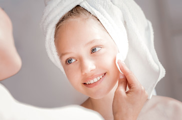 Beautiful young face. Portrait of a delighted happy girl smiling and feeling positive while looking at her mother