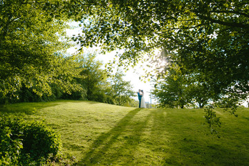 Silhouette of beautiful wedding couple near a trees at the evening. Artwork