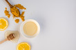 Honey stick, spoon with turmeric and lemon slices top view, copy space