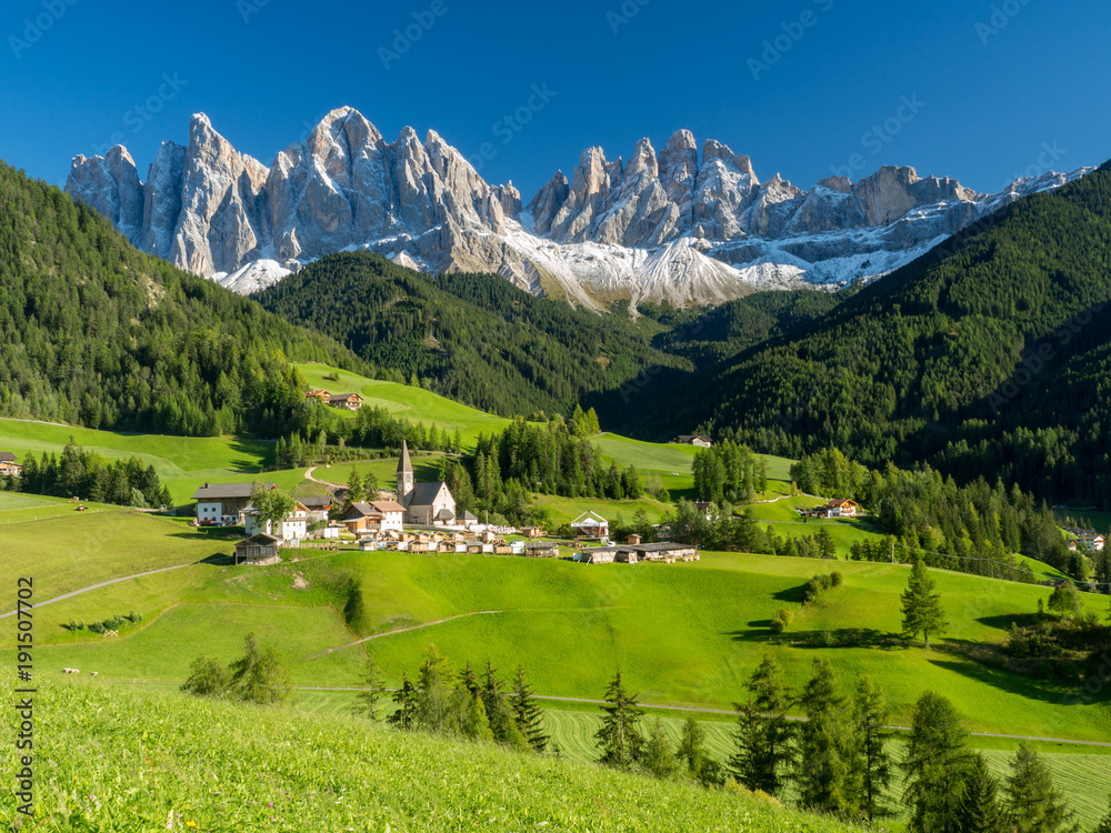 Val di Funes valley, Santa Maddalena touristic village, Dolomites, Italy, Europe. September, 2017. Green grass and blue sky. - obrazy, fototapety, plakaty 