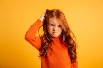 Confused little redhead girl