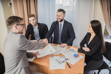 Wall Mural - handshake at the signing of the contract in the office of businessmen