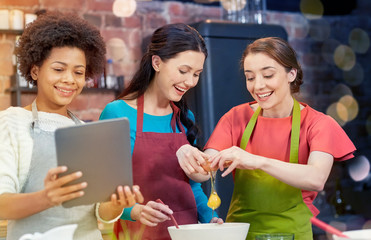 Poster - happy women with tablet pc in kitchen