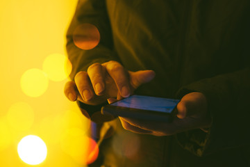 Canvas Print - Woman using smartphone on street at night