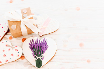  happy mother's day greeting card. cookie heart with lavender flowers and craft gift box on white rustic wood background  flat lay. space for text. happy valentine's day or women's