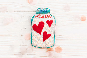 Wall Mural - happy valentine's day greeting card. jar with colorful cookie hearts on white rustic wooden background with confetti flat lay. space for text . mock-up. happy mother's day or women's