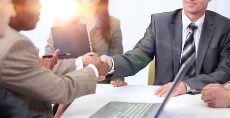 handshake business partners at a business meeting