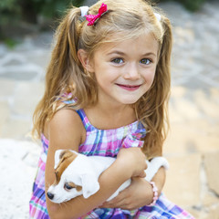 Pretty little girl with a cute puppy. Jack Russel terrier puppy	