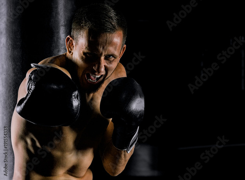 Professional sportsman of mixed martial arts stands in the fighting stance and beats with the krim on the enemy Fototapete