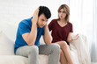 © ake1150 - Couple having argument conflict, bad relationships. Angry fury woman screaming man close his ears in house.