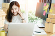 © jumlongch - Young asian girl is freelancer with her private business at home office, working with laptop, coffee, online marketing, Customer order and packaging or packing.