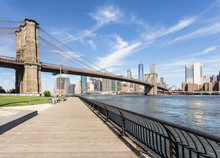 The Famous Brooklyn Bridge, From DUMBO, With The Manhattan Financial District On The Other Side Of The East River In New York City On A Sunny Day In The USA