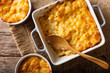 Delicious and hearty meal: casserole mac and cheese in a baking dish close-up. horizontal top view