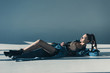 © LIGHTFIELD STUDIOS - beautiful woman in denim clothes lying on floor with shadows