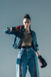 © LIGHTFIELD STUDIOS - stylish girl in denim clothes posing with boxing gloves, isolated on grey