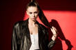 © LIGHTFIELD STUDIOS - stylish girl with ponytail hairstyle posing in black leather jacket for fashion shoot